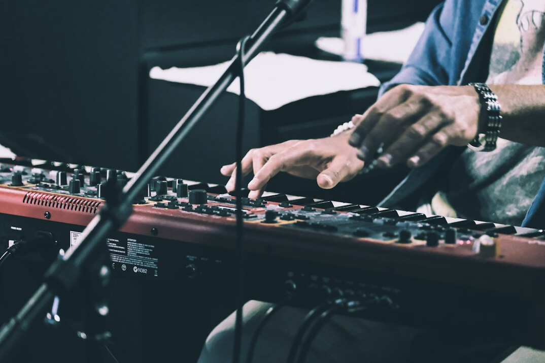 Sound engineer adjusting levels on a broadcast mixing console